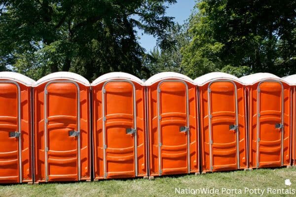 a lineup of clean and well-maintained portable loos for workers in Pahala, HI